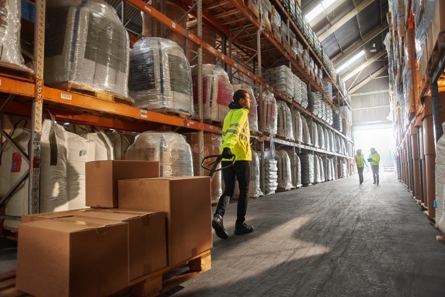 man in warehouse pulling stock in boxes